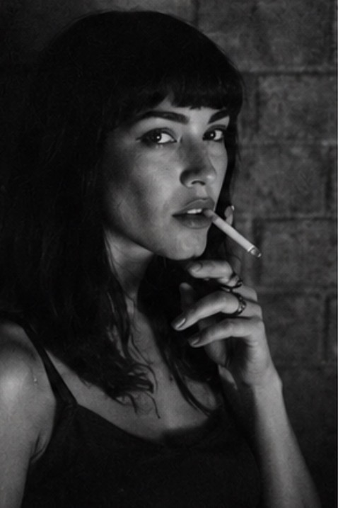 Kapok — black-and-white portrait, cigarette in hand